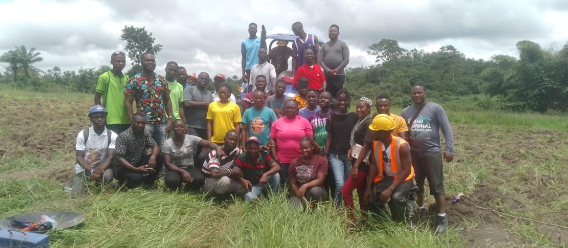 Facilitators conducting practical training sessions with interns and farm machine operators in the fields