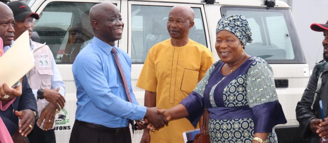 Minister Nuetah handover keys to Mrs. Kromah as Mr. Momo and Joseph Woah look on.