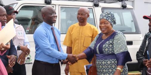 Minister Nuetah handover keys to Mrs. Kromah as Mr. Momo and Joseph Woah look on.